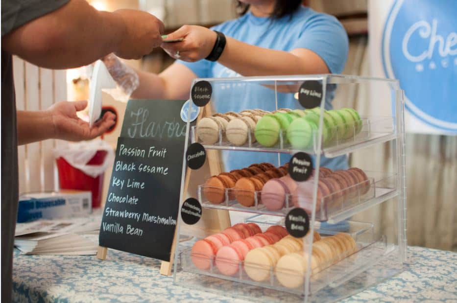 A woman selling homemade Macaroons.