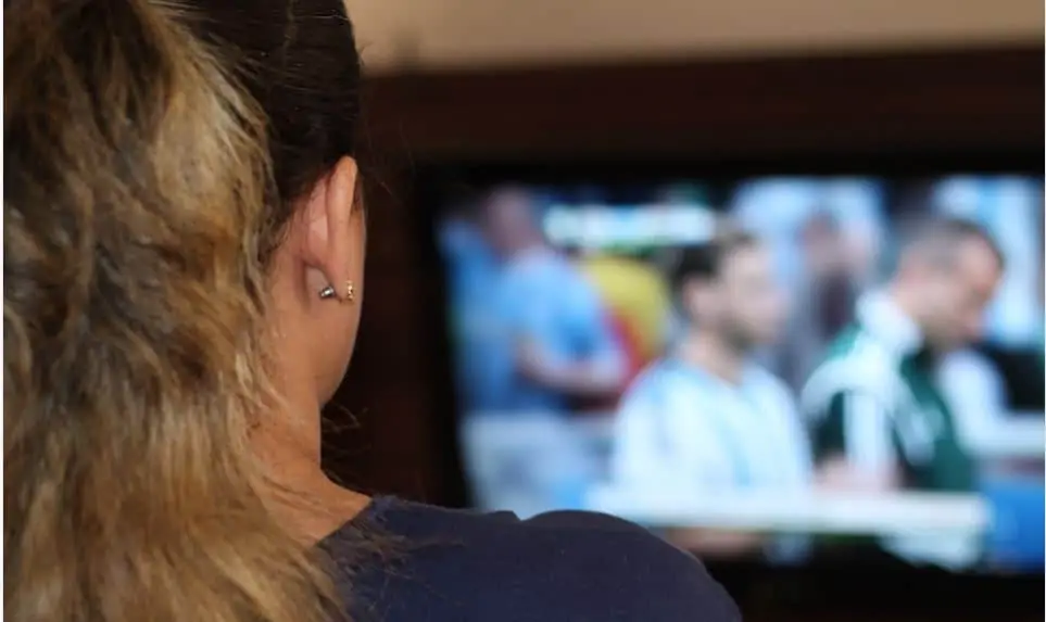 A woman watching cable TV.