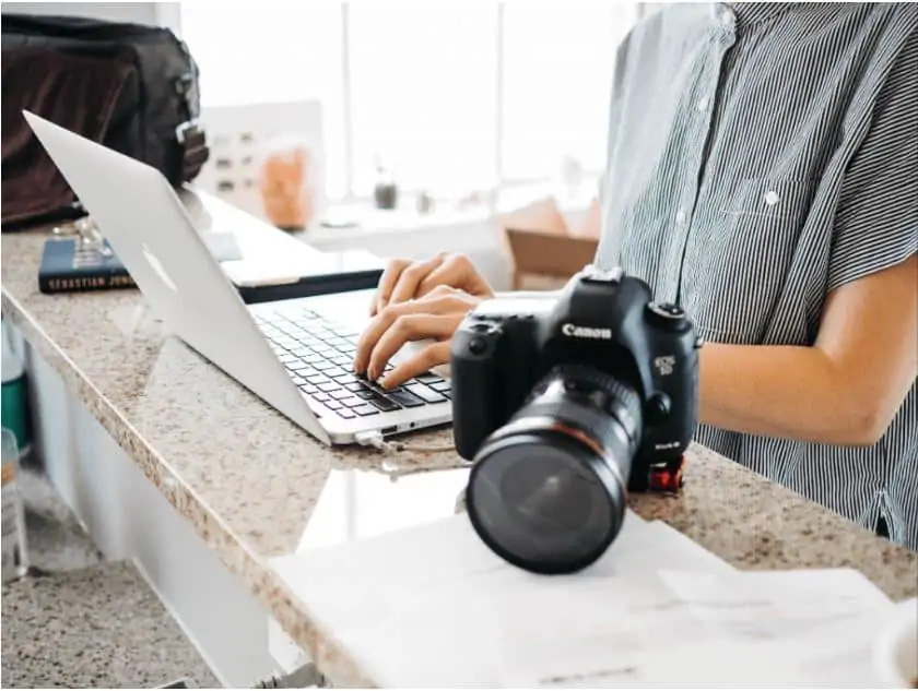person at a laptop working as a photographer 
