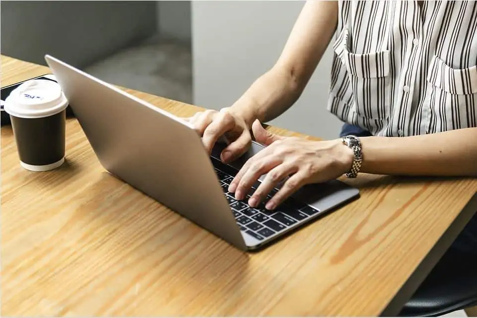 A woman working as a social media manager from her laptop.