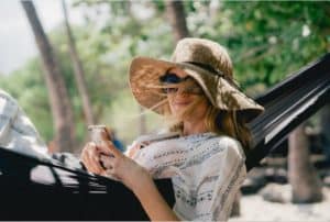 A woman in a hat and sunglasses enjoying a day off.