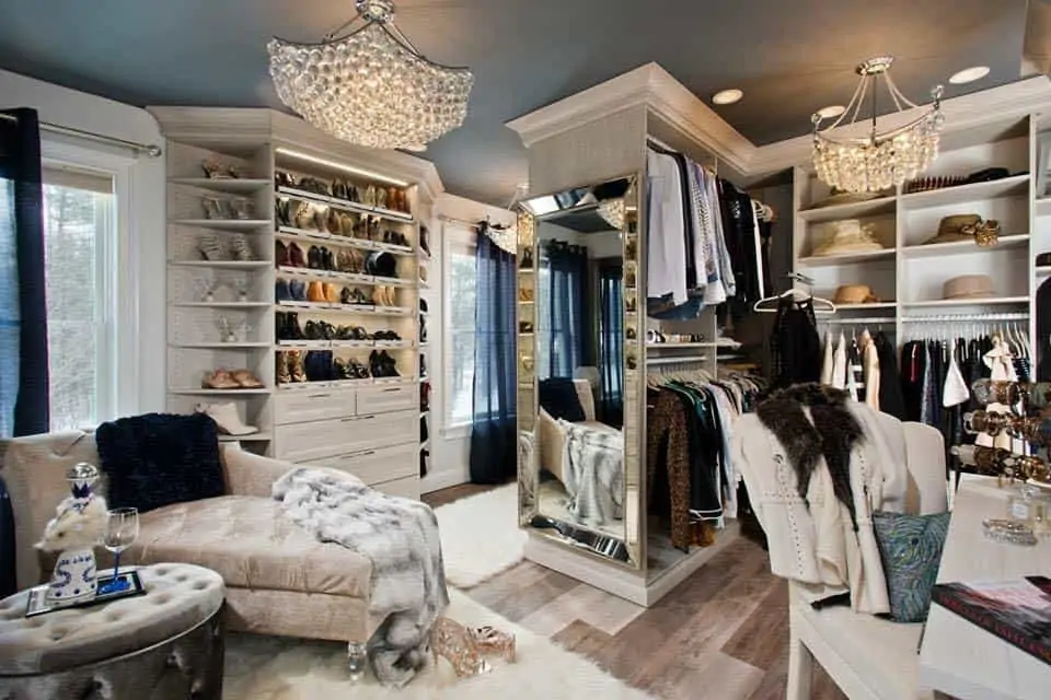 An extravagant closet with shoes and clothes. 