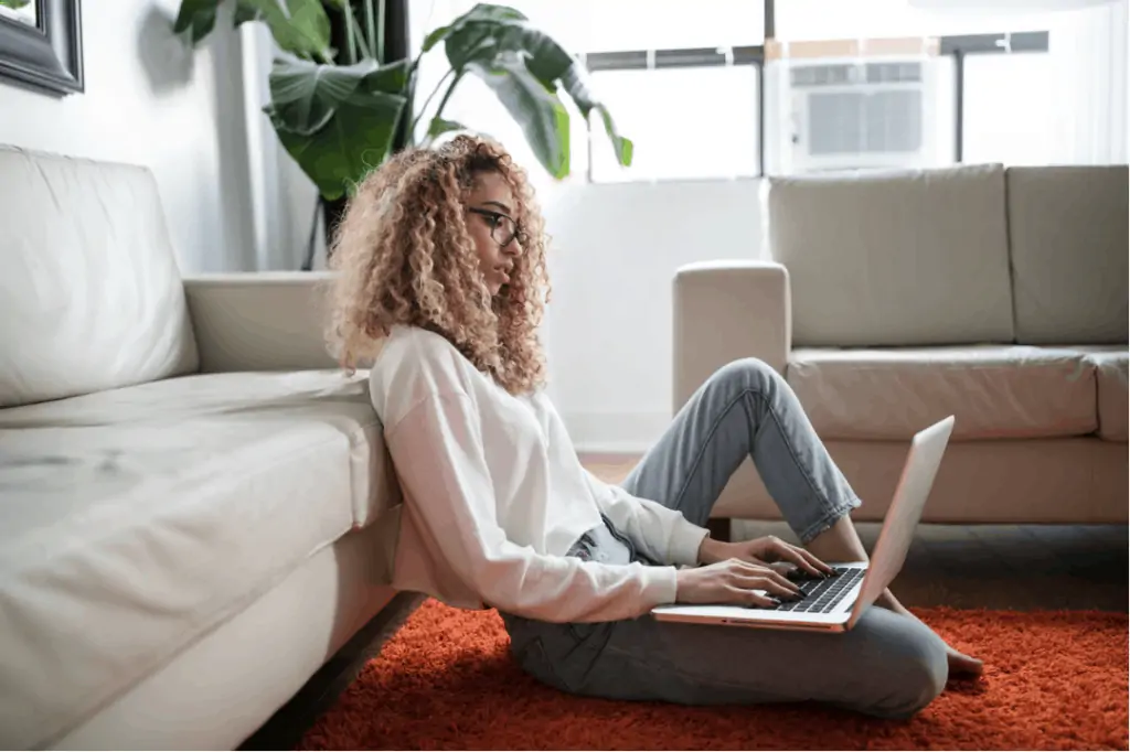 A mom working on her laptop as a freelance writer from home