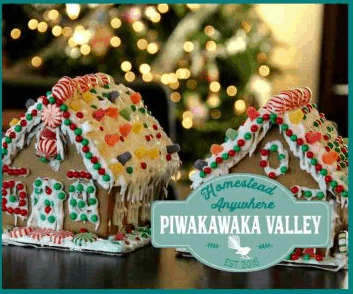 Nicely decorated gingerbread houses with lit Christmas tree in background.