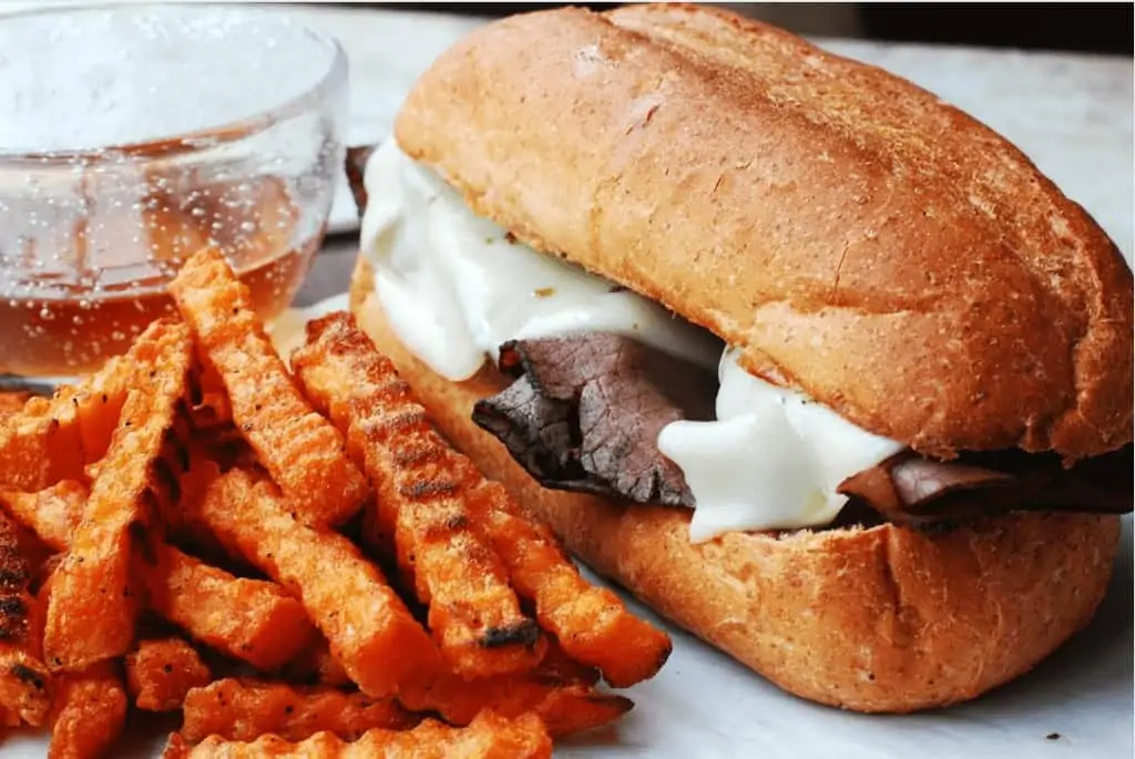 A roast beef sandwich with sweet potato fries