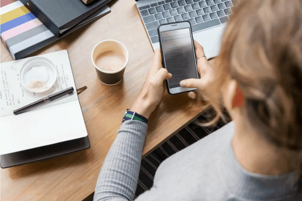 Woman on her phone looking for a online job from home without investment. 