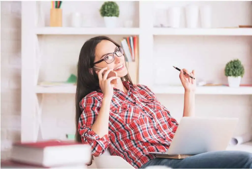 A smiling woman working from home.