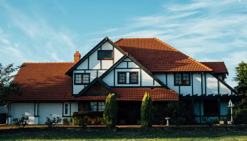 Large white home with a brown roof