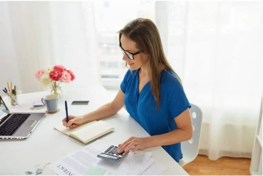 woman sitting at a desk working on virtual bookkeeping 