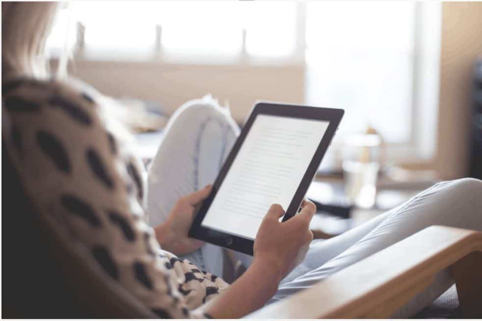 woman on a tablet working on proofreading 