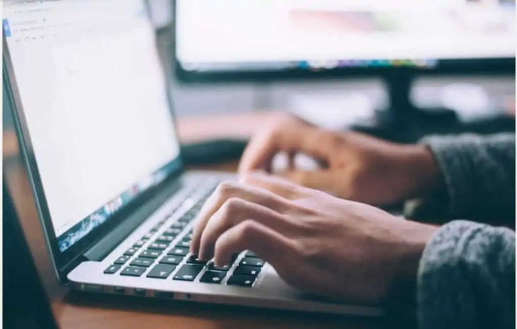 person on their laptop working on transcribing 