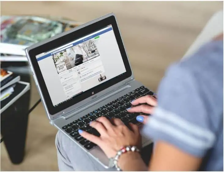 A woman working on a laptop as a social media manager