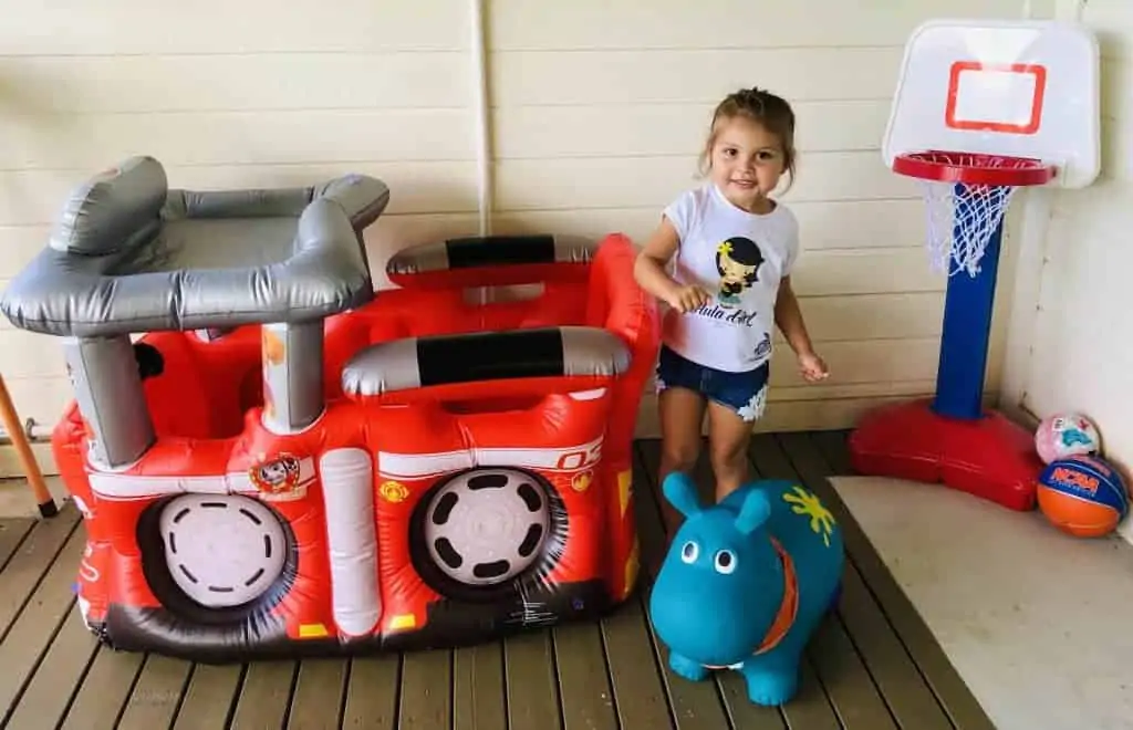 A little girl playing on an inflatable toy from a rental business