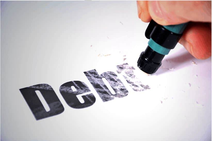 A person erasing the word debt