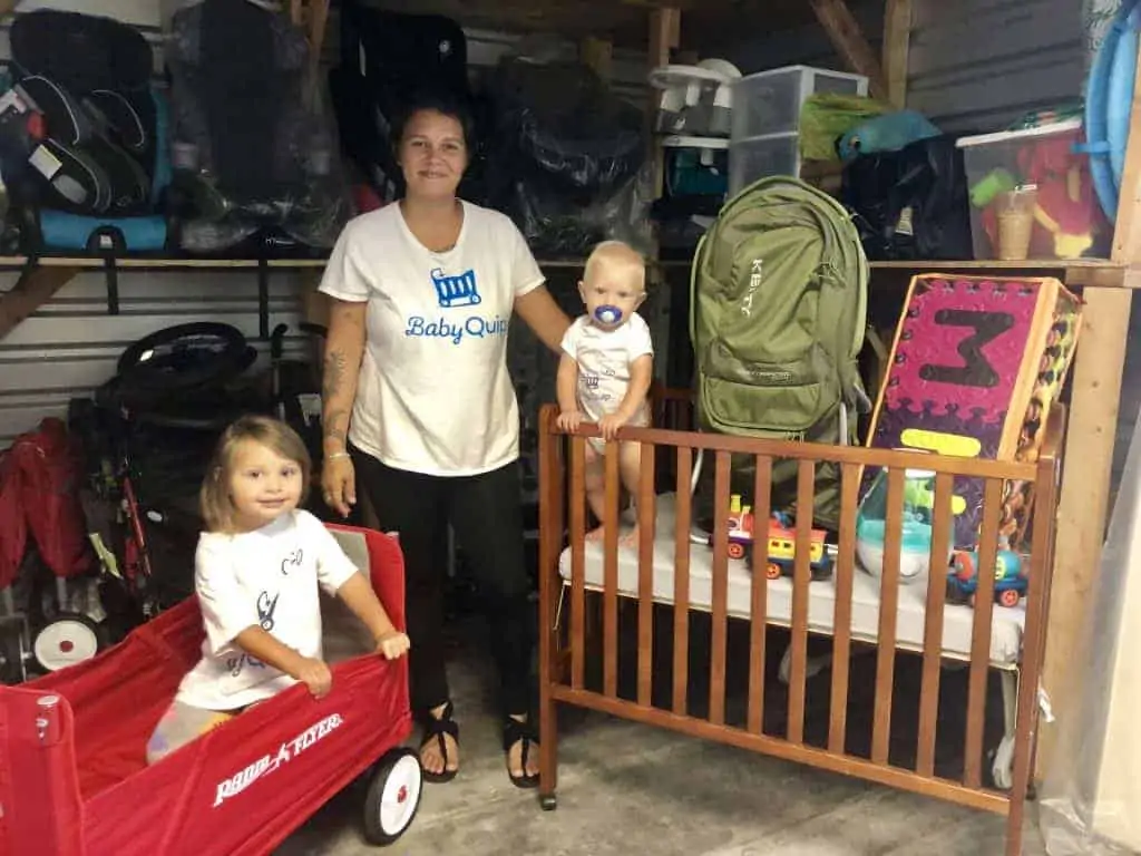 A mom and her children looking for baby rental equipment in a store