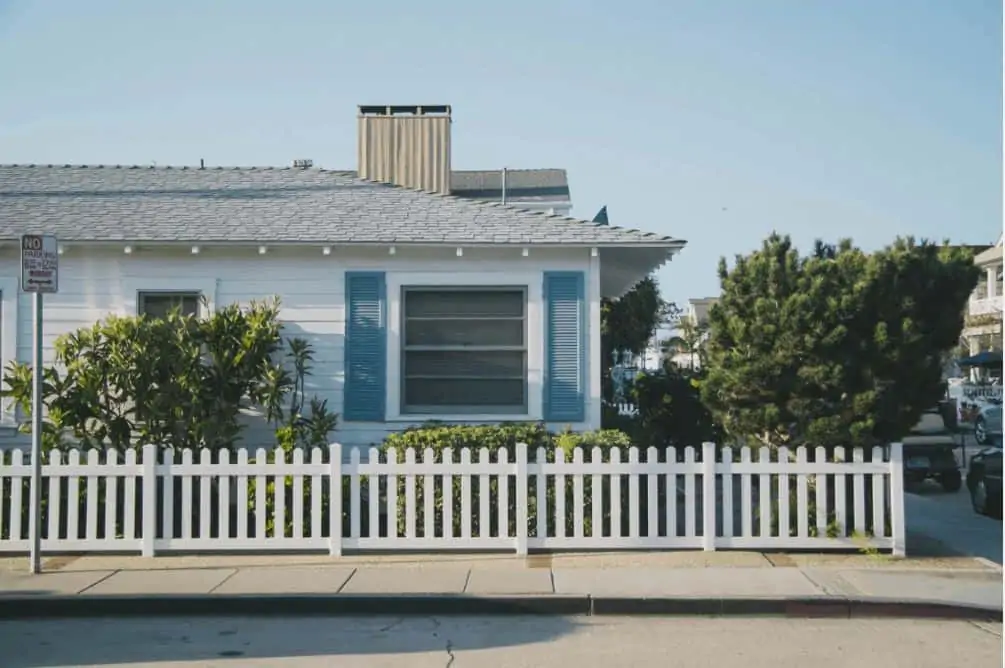 A small blue and white house in foreclosure.