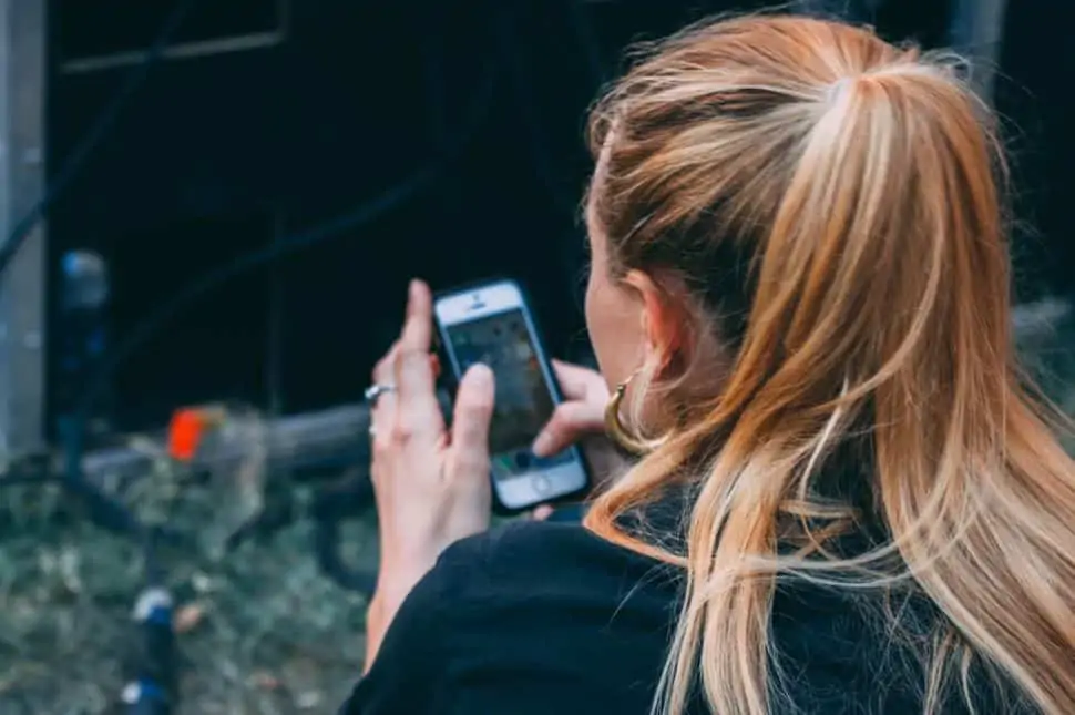 woman on her phone searching for the best survey apps of 2020