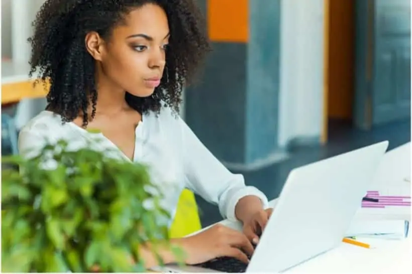 a woman working on her laptop as a transcriber