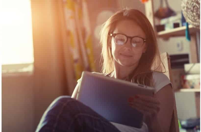 woman on her tablet proofreading 