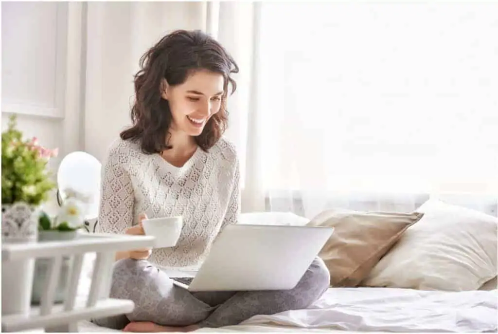 A woman working from home as a virtual assistant on her laptop