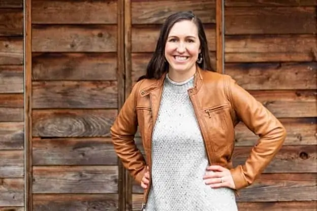 woman who makes printables on etsy smiling in a leather jacket