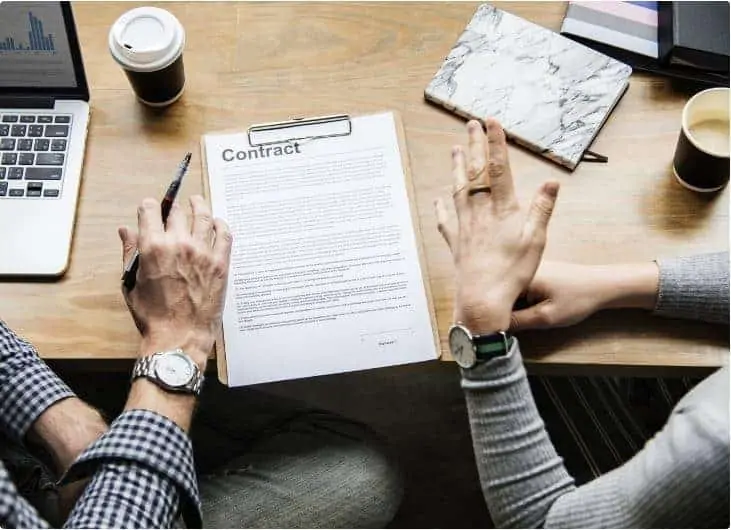 People discussing a loan and getting ready to sign