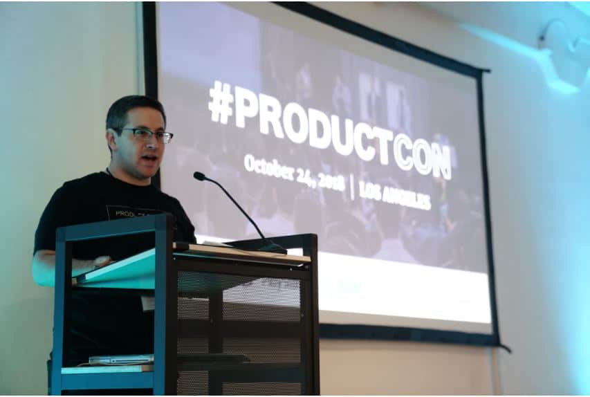 A man giving a speech about production