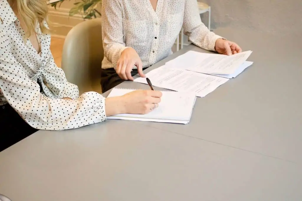 Two woman working together on signing a loan 