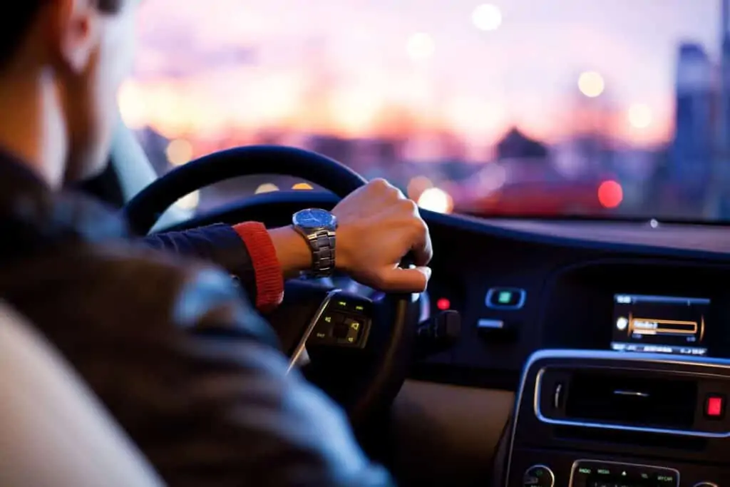 A man driving a car doing deliveries for DoorDash