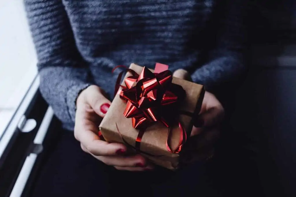 Picture of a person holding a wrapped gift