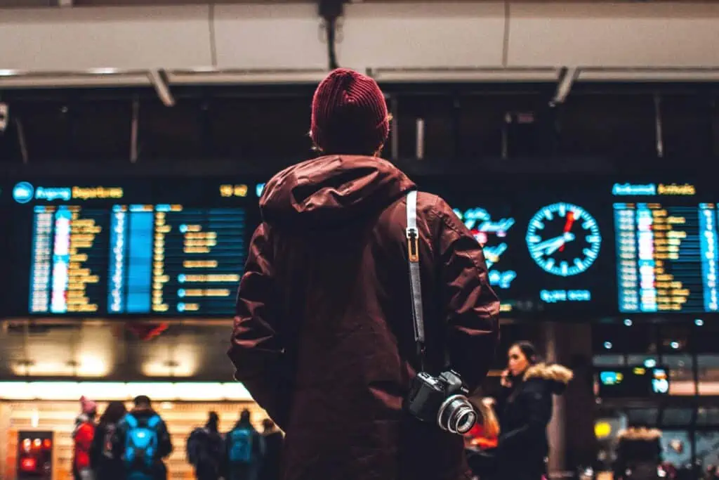 a man standing in front of a airport or train station