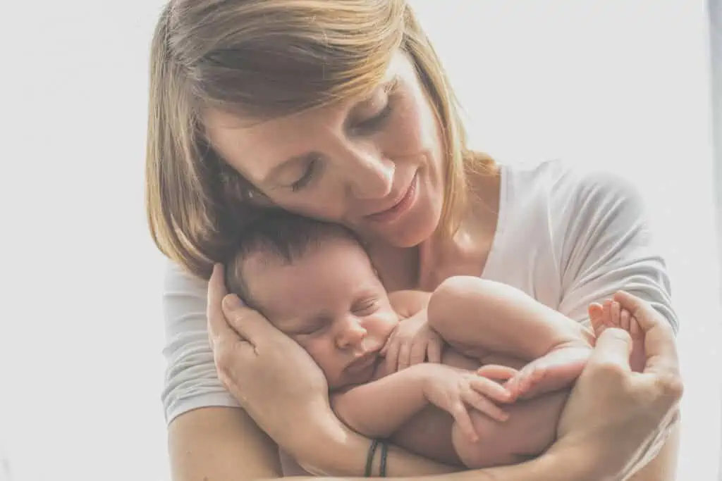 woman holding sleeping baby