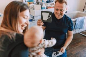 Man and woman practicing flashcards with their baby