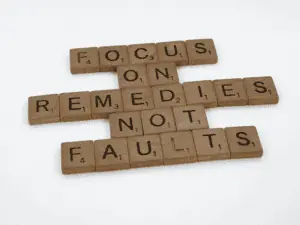 Scrabble tiles spelling Focus on remedies not faults