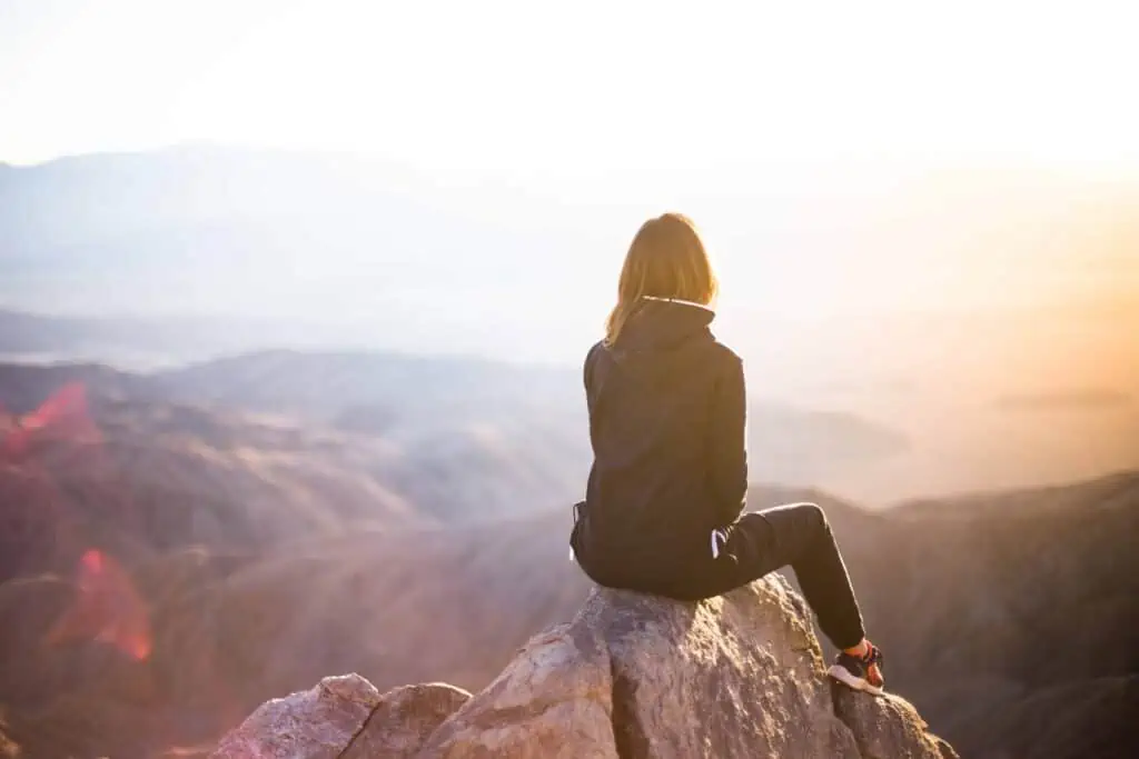 A woman sitting on a cliff