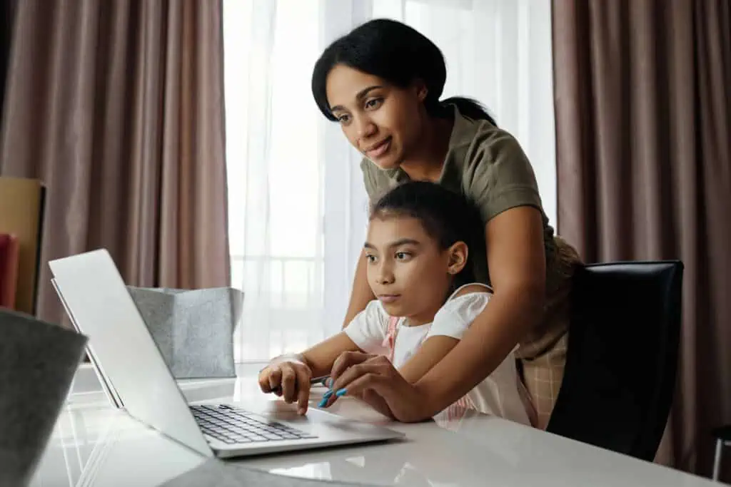 A woman teaching her daughter from home